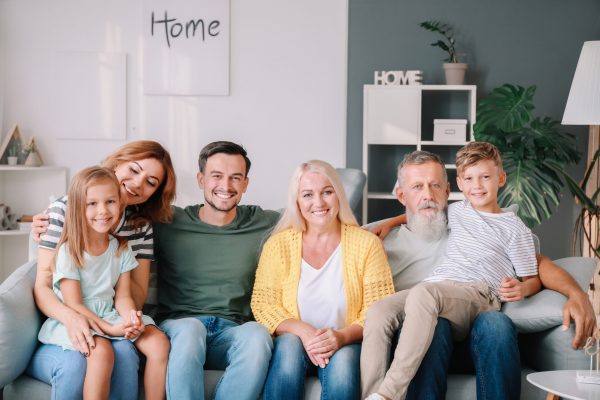 Big family sitting together on couch at home